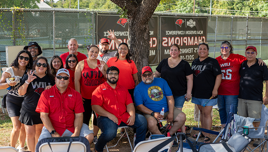 Cardinal families seated at UIW tailgate